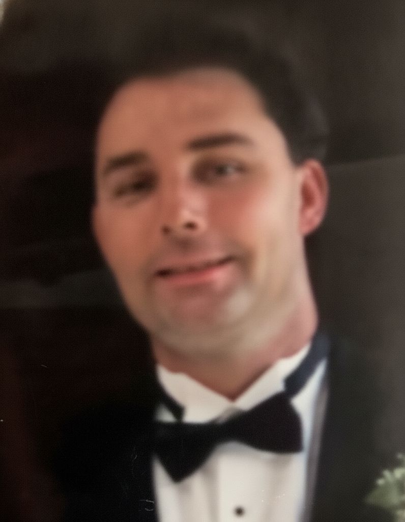 JOHN J. SHIELS