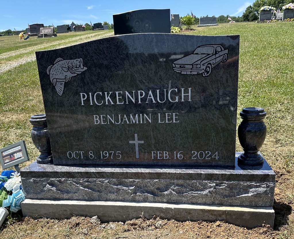 Bahama Blue upright monument with fishing and vehicle designs and two vases
